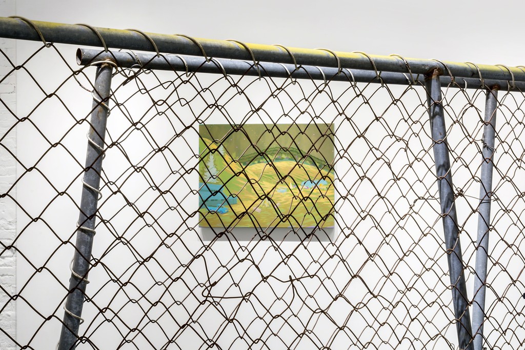 "Golden Hours" by Jen Hitchings seen through sections of modified chain link fence in the gallery space. "Golden Hours" by Jen Hitchings seen through sections of modified chain link fence in the gallery space.
