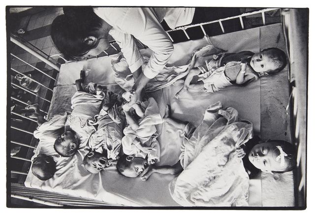 Philip Jones Griffiths, ‘Orphans from the Vietnamese war in a hospital cot’, c.1968, Photography, Vintage gelatin silver print, Roseberys