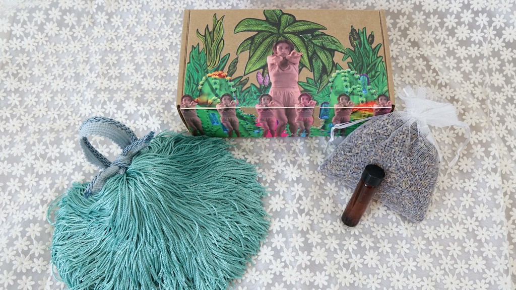Sonia Li, Pleasure Box, 2020, tassels, lavender, calendula oil and rose water in cardboard box.
Inspired by the novel Pangs of Love by David Wong Louie in the MOCA archive, this work contains interactive objects meant to be used to cultivate an intimate relationship within the act of giving pleasure to one another. The tassel object is pleasant to the touch, lavender pouch is a calming scent, and the love potion is a blend of rose water and calendula oil for sensual pleasure. Sonia Li, Pleasure Box, 2020, tassels, lavender, calendula oil and rose water in cardboard box.
Inspired by the novel Pangs of Love by David Wong Louie in the MOCA archive, this work contains interactive objects meant to be used to cultivate an intimate relationship within the act of giving pleasure to one another. The tassel object is pleasant to the touch, lavender pouch is a calming scent, and the love potion is a blend of rose water and calendula oil for sensual pleasure.