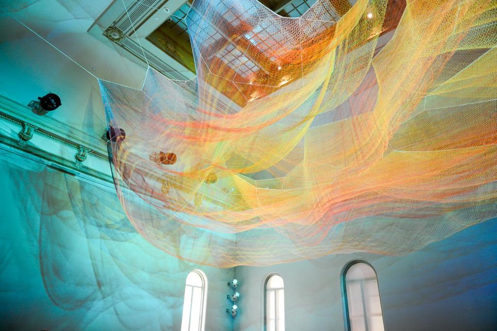 Janet Echelman, 1.8 Renwick, 2015, knotted and braided fiber with programmable lighting and wind movement above printed textile flooring, Smithsonian American Art Museum, photo by Tony Powell Janet Echelman, 1.8 Renwick, 2015, knotted and braided fiber with programmable lighting and wind movement above printed textile flooring, Smithsonian American Art Museum, photo by Tony Powell