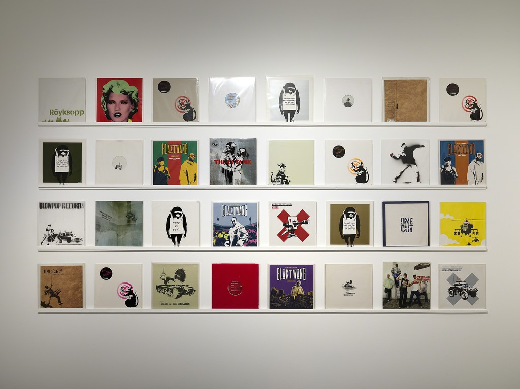In addition to street murals, canvases and limited edition prints, Banksy has produced a variety of commissioned works such as album cover art. These are extremely rare collectors items and now showing in the War, Capitalism & Liberty museum exhibition on through September 2016. In addition to street murals, canvases and limited edition prints, Banksy has produced a variety of commissioned works such as album cover art. These are extremely rare collectors items and now showing in the War, Capitalism & Liberty museum exhibition on through September 2016.