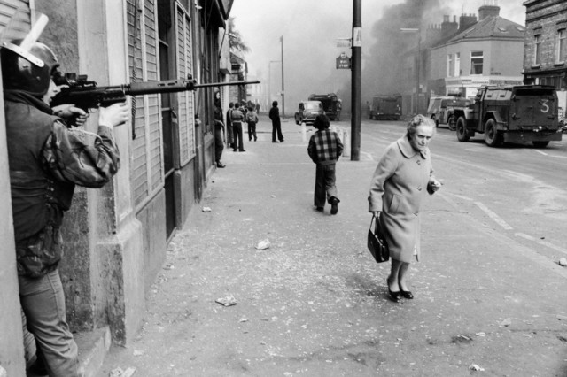 Chris Steele Perkins, ‘Catholic West Belfast Ð Falls Road Ð Hijacked vehicle burns tin the background marking the anniversary of the British Policy of internment without trial. Northern Island, Great Britain’, 1978, Photography, Magnum Photos