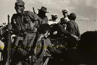 Fidel Castro riding into Havana during the revolution escorted by Cuban Naval officers
