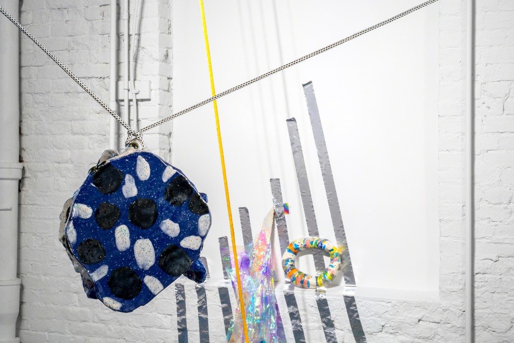 A glazed ceramic element suspended as part of an installation by Denise Treizman. A glazed ceramic element suspended as part of an installation by Denise Treizman.