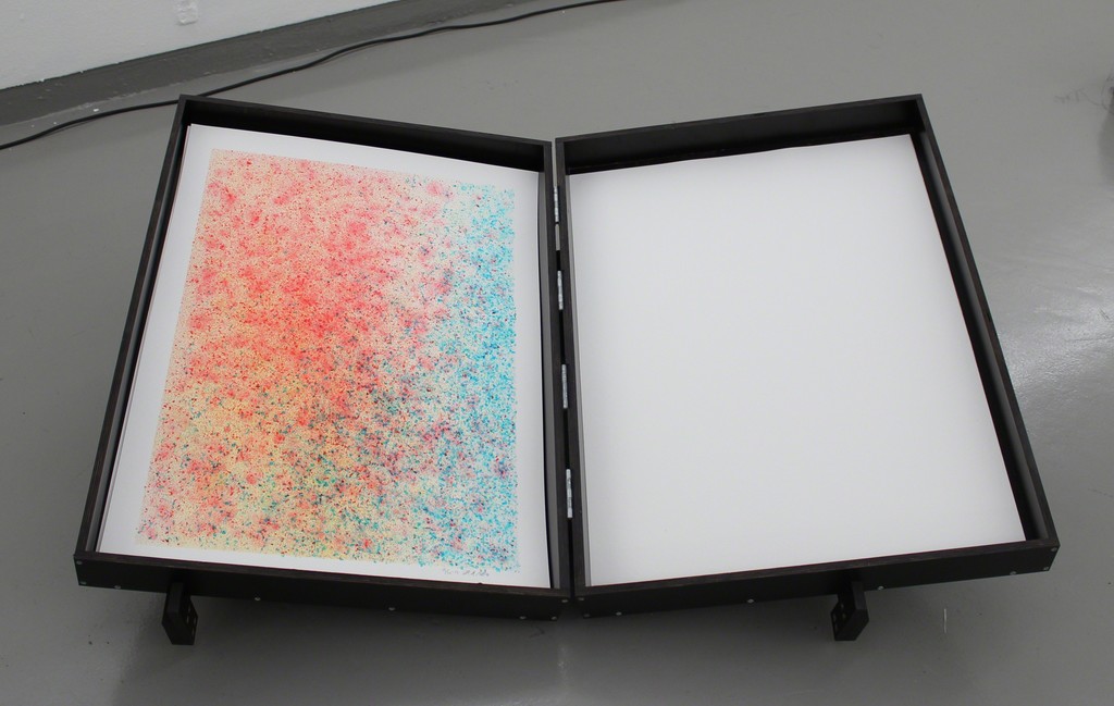 SB007 Watercolour Tool (Installation), 2016, Panels, electronics, paper and soap, 160 x 90 x 135 cm. With help from soap bubbles SB007 paints watercolors in red, yellow and blue. The colour of the soapwater is controlled by the daylight, and the colour is blown out in bubbles bursting on the paper consequently leaving a mark. Slowly the day appears on the paper. Aware of its own nature-romantic tradition the SB007 works with the ’special’ Nordic light as a catalyst of the artistic process. SB007 Watercolour Tool (Installation), 2016, Panels, electronics, paper and soap, 160 x 90 x 135 cm. With help from soap bubbles SB007 paints watercolors in red, yellow and blue. The colour of the soapwater is controlled by the daylight, and the colour is blown out in bubbles bursting on the paper consequently leaving a mark. Slowly the day appears on the paper. Aware of its own nature-romantic tradition the SB007 works with the ’special’ Nordic light as a catalyst of the artistic process.
