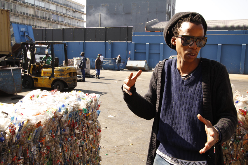 Thabo Pitso at the Scrapyard picking material for his sculptures. Thabo Pitso at the Scrapyard picking material for his sculptures.
