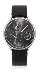 A fine and unusual titanium wristwatch with orbiting hour, day display, frisbee, warranty card and presentation box