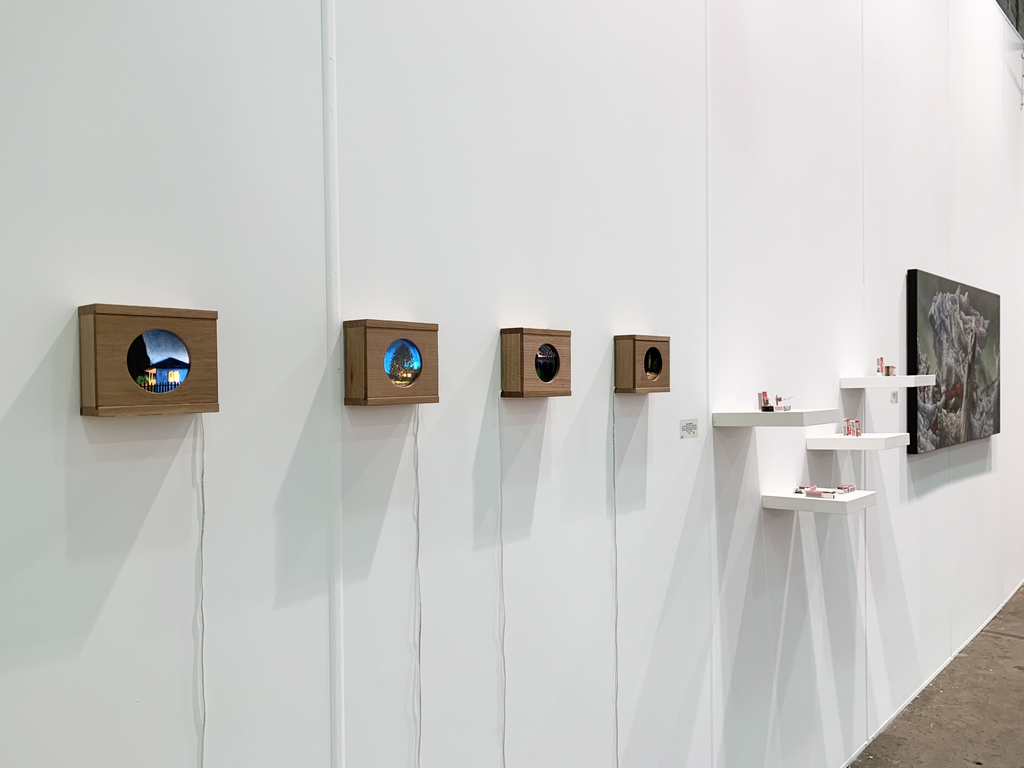 MAY SPACE at Booth G09 - Installation I, 10th September, 2019, featuring:
Waratah Lahy, 'Welcome Home'; 'House hiding behind trees'; 'Twofold'; 'Park at night 2', 2019, oil on glass, recycled Tasmanian oak light boxes.
Mylyn Nguyen, collection of matchbox sculptures.
James Guppy, 'Fire and Ash,' 2019, acrylic on polycotton. MAY SPACE at Booth G09 - Installation I, 10th September, 2019, featuring:
Waratah Lahy, 'Welcome Home'; 'House hiding behind trees'; 'Twofold'; 'Park at night 2', 2019, oil on glass, recycled Tasmanian oak light boxes.
Mylyn Nguyen, collection of matchbox sculptures.
James Guppy, 'Fire and Ash,' 2019, acrylic on polycotton.
