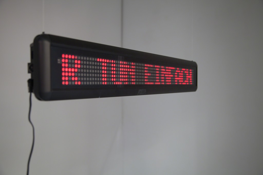 „Wir tun einfach, als ob wir nicht da sind“ (engl.: we will act as if we are not there), 2010, exhibition view | LED screen, 70 x 11 x 4,5 cm | image: ©dasesszimmer „Wir tun einfach, als ob wir nicht da sind“ (engl.: we will act as if we are not there), 2010, exhibition view | LED screen, 70 x 11 x 4,5 cm | image: ©dasesszimmer