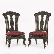 A pair of Anglo-Ceylonese ebony hall chairs