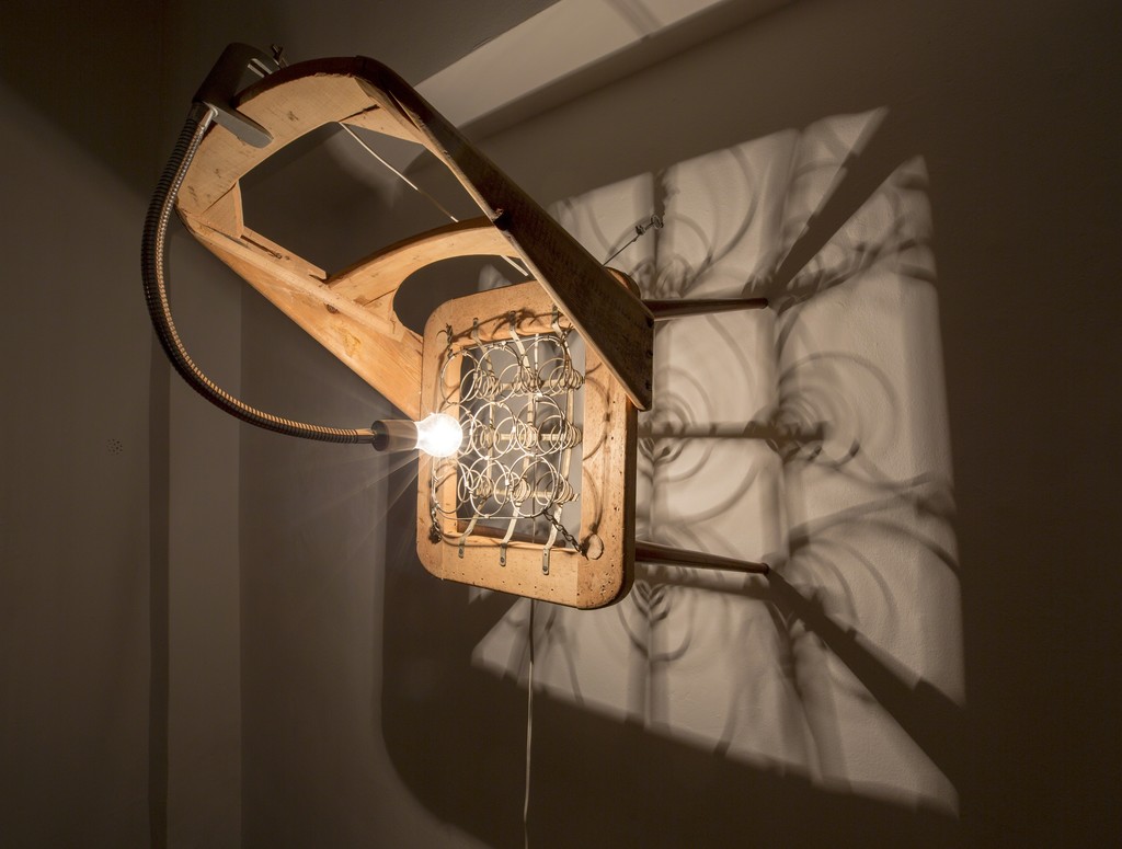 Cell Block D, 2018, Sculpture/Performance/Installation, Un upholstered chair with light fixture, 46 x 48 x 81 cm Cell Block D, 2018, Sculpture/Performance/Installation, Un upholstered chair with light fixture, 46 x 48 x 81 cm