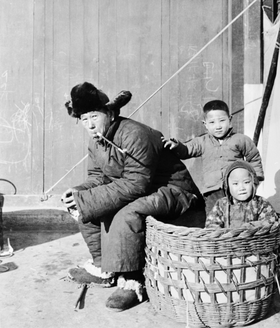 Hedda Morrison, ‘Man and children enjoying the winter sunshine’, ca. 1940, Powerhouse Museum
