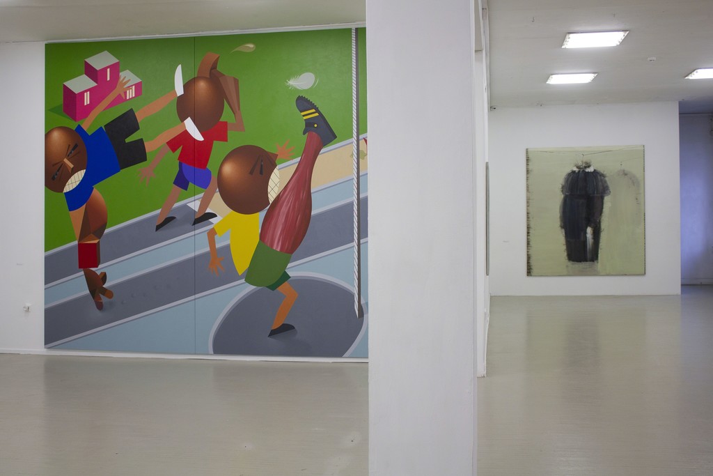 Fragment of exhibition "Družba".
On the left: Kaido Ole, "Baltic Match". 2016. Oil and acrylic on canvas, 330 x 390 cm.
On the right: Jonas Gasiūnas, A SCHOOL DRESS. 2017. Oil and charcoal (from candle smoke) on canvas, 230 x 210 cm. Fragment of exhibition "Družba".
On the left: Kaido Ole, "Baltic Match". 2016. Oil and acrylic on canvas, 330 x 390 cm.
On the right: Jonas Gasiūnas, A SCHOOL DRESS. 2017. Oil and charcoal (from candle smoke) on canvas, 230 x 210 cm.