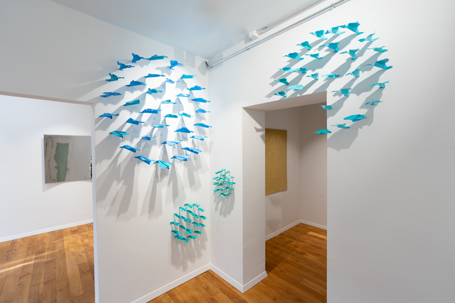 100 paper planes simultaneously hitting the wall with a deep sense of geometry
