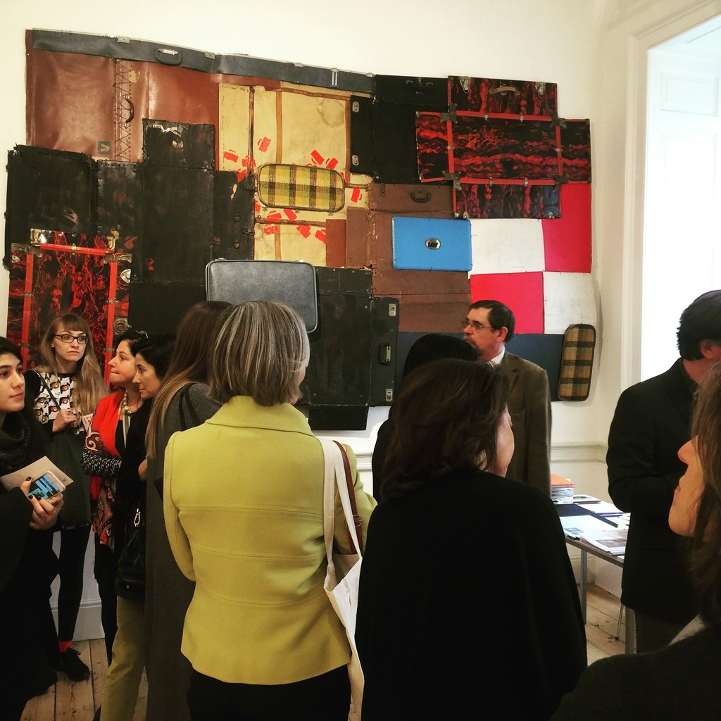 a crowded booth with Bright Ugochuwu Eke's Portmanteau, 2015 in the background. a crowded booth with Bright Ugochuwu Eke's Portmanteau, 2015 in the background.