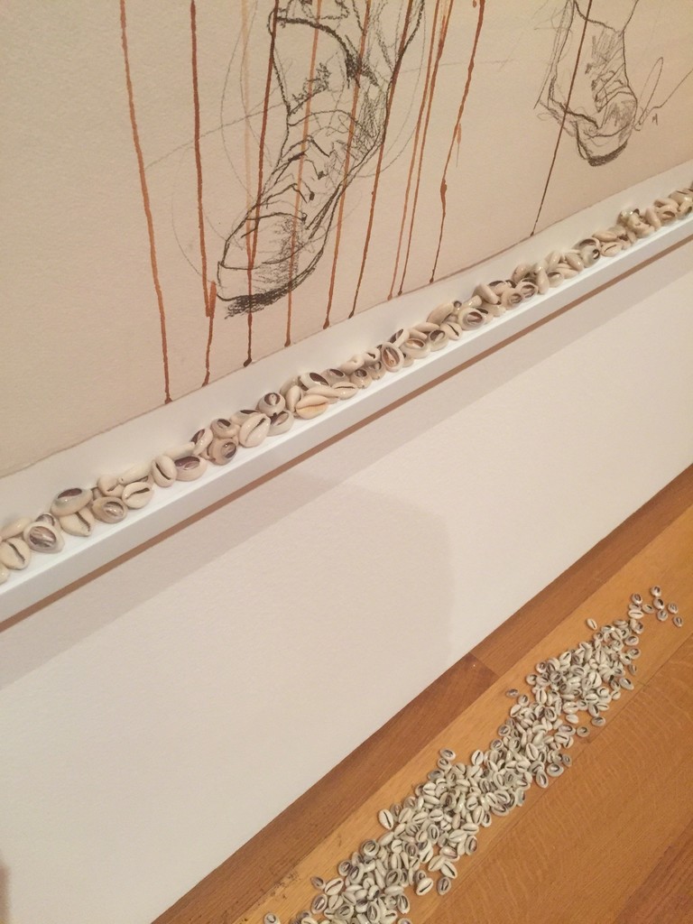 Detail view of the cowries at the bottom of "The Messenger" frame.
2014, Acrylic and graphite on paper with cowries. Detail view of the cowries at the bottom of "The Messenger" frame.
2014, Acrylic and graphite on paper with cowries.