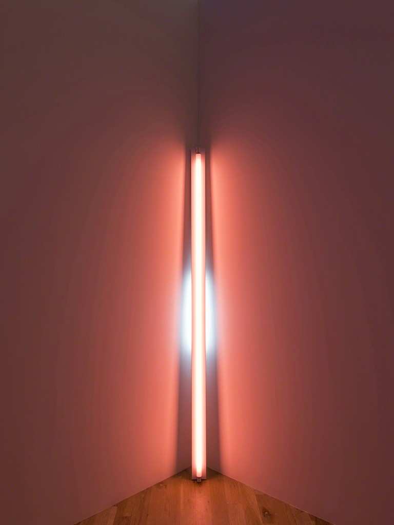 Dan Flavin, untitled (to Shirley and Jason), 1969. Pink and blue fluorescent light. 8 ft. leaning into a corner with the top of the 20W tube touching the corner. Installation view: Dan Flavin: cornered fluorescent light, Mana Contemporary, Jersey City, 2018. Photo: John Berens. Courtesy of the Estate of Dan Flavin Dan Flavin, untitled (to Shirley and Jason), 1969. Pink and blue fluorescent light. 8 ft. leaning into a corner with the top of the 20W tube touching the corner. Installation view: Dan Flavin: cornered fluorescent light, Mana Contemporary, Jersey City, 2018. Photo: John Berens. Courtesy of the Estate of Dan Flavin