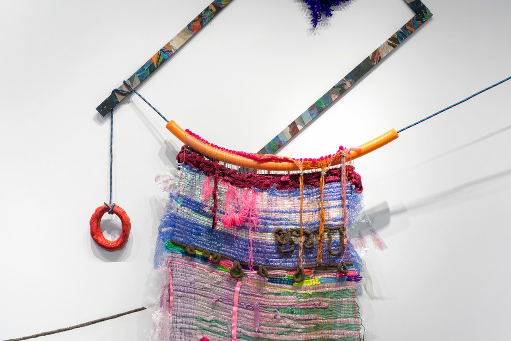 A detail of a large textile work installed in combination with a glazed ceramic piece and other found materials. A detail of a large textile work installed in combination with a glazed ceramic piece and other found materials.
