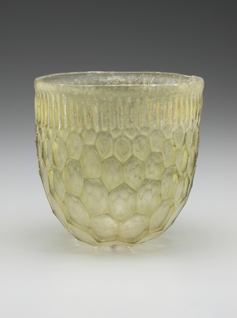 Honeycomb Beaker, Roman, Eastern Mediterranean or Western Empire, 4th century A.D. Cast and free-blown glass, H. 4 5/8 × DIAM. 4 ¾ in. (11.7 × 12.1 cm). Yale University Art Gallery, Hobart and Edward Small Moore Memorial Collection, Bequest of Mrs. William H. Moore, 1955.6.71 Honeycomb Beaker, Roman, Eastern Mediterranean or Western Empire, 4th century A.D. Cast and free-blown glass, H. 4 5/8 × DIAM. 4 ¾ in. (11.7 × 12.1 cm). Yale University Art Gallery, Hobart and Edward Small Moore Memorial Collection, Bequest of Mrs. William H. Moore, 1955.6.71
