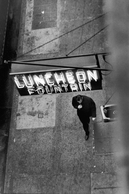 David Vestal, ‘Man Walking Under Neon Sign, West 22nd Street, NYC’, 1958, Photography, Silver print, Robert Mann Gallery