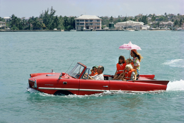 Slim Aarons, ‘Sea Drive, 1967: Film producer Kevin McClory takes his wife Bobo Segrist and their family for a drive in an “Amphicar” across the harbour at Nassau, Bahamas’, 1967, Staley-Wise Gallery