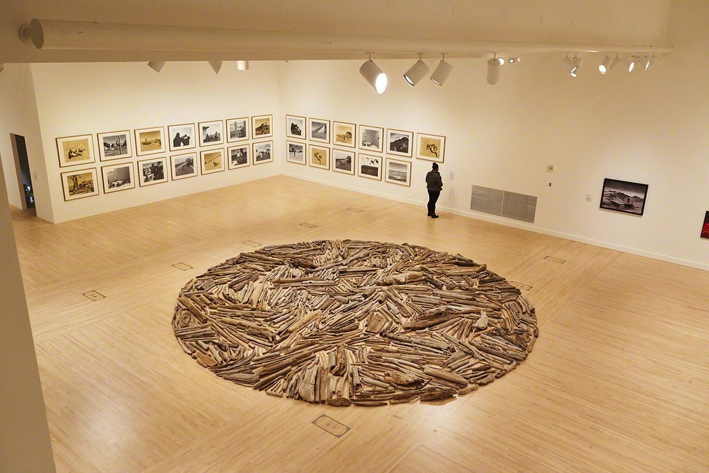 A guest observing "Up in the Sky," a 1997 work by Tracey Moffatt. Richard Long's 1996 piece "Puget Sound Driftwood Circle" is in the foreground.
Photo credit: Jonathan Wanderweit. A guest observing "Up in the Sky," a 1997 work by Tracey Moffatt. Richard Long's 1996 piece "Puget Sound Driftwood Circle" is in the foreground.
Photo credit: Jonathan Wanderweit.