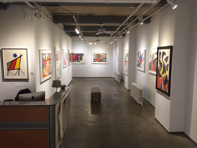 Gallery shot of Alexander Calder: Sharing Negative Space, featuring lithographs, original watercolors and stable from Alexander Calder. (Works shown from left to right -"Blue Sun", "Spirale Rouge & Bleu", "The Way of the World", "The Letters","The Bug" and "Kissing Man", "The Waves" "Untitled(Blue and Red Sun)", "Black Anatomy", and "Untitled" ) Gallery shot of Alexander Calder: Sharing Negative Space, featuring lithographs, original watercolors and stable from Alexander Calder. (Works shown from left to right -"Blue Sun", "Spirale Rouge & Bleu", "The Way of the World", "The Letters","The Bug" and "Kissing Man", "The Waves" "Untitled(Blue and Red Sun)", "Black Anatomy", and "Untitled" )