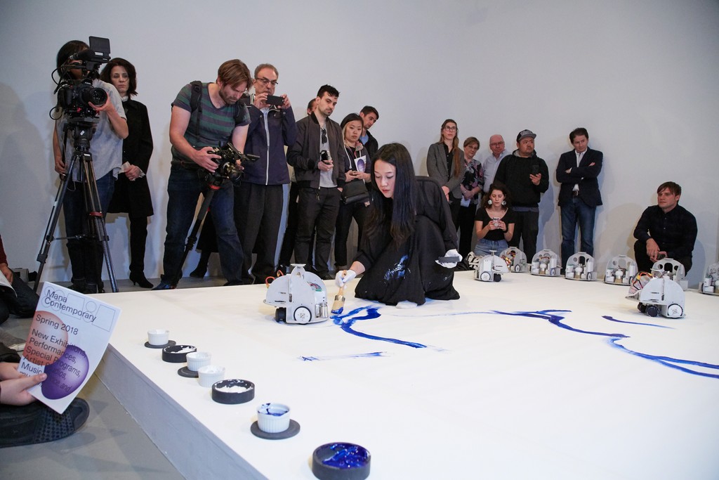 Sougwen Chung's performance of "Omnia per Omnia,"April 29, 2018, part of "Only Human" April 29–June 2, 2018, Mana Contemporary, Jersey City, NJ. Courtesy of New Museum and NEW INC. Photo: Jesse Untracht-Oakner. Sougwen Chung's performance of "Omnia per Omnia,"April 29, 2018, part of "Only Human" April 29–June 2, 2018, Mana Contemporary, Jersey City, NJ. Courtesy of New Museum and NEW INC. Photo: Jesse Untracht-Oakner.