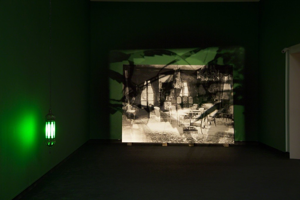 Installation shot of Joachim Koester's The Hashish Club, 2009. Installation: 16 mm black-and-white film loop, black-and-white photograph and two green Moroccan lamps. Photo from the exhibition 'Fire under Snow: New film and video works at Louisiana', 27.1.-8.5.2016, Louisiana Museum of Modern Art. Installation shot of Joachim Koester's The Hashish Club, 2009. Installation: 16 mm black-and-white film loop, black-and-white photograph and two green Moroccan lamps. Photo from the exhibition 'Fire under Snow: New film and video works at Louisiana', 27.1.-8.5.2016, Louisiana Museum of Modern Art.