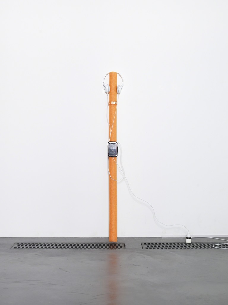 Cory Arcangel, Emo kid, 2014 / Foam pool noodle, Sony headphones, Apple iPod classic, Apple iPod charger, Apple iPod case, My Chemical Romance “I’m Not Okay (I Promise)” MPEG- 1 Audio Layer III file, snap wristband.
140 cm (high), width variable, depth variable © the artist; Courtesy, Lisson Gallery, London Cory Arcangel, Emo kid, 2014 / Foam pool noodle, Sony headphones, Apple iPod classic, Apple iPod charger, Apple iPod case, My Chemical Romance “I’m Not Okay (I Promise)” MPEG- 1 Audio Layer III file, snap wristband.
140 cm (high), width variable, depth variable © the artist; Courtesy, Lisson Gallery, London