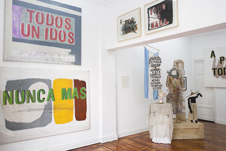 Exhibition view with works from the series "Pancartas" by Gustavo Marrone and installation of costumes and props by Batato Barea. Exhibition view with works from the series "Pancartas" by Gustavo Marrone and installation of costumes and props by Batato Barea.