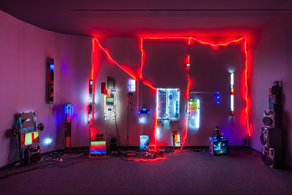 Kiosk (Electronic Relations), 2014–2016
Installation: HD video (3-D animation),
RCA cables, computer LED screens,
glass, Perspex, heat sensors, speakers,
LED lights, media players, Photo: Tal Nisim Kiosk (Electronic Relations), 2014–2016
Installation: HD video (3-D animation),
RCA cables, computer LED screens,
glass, Perspex, heat sensors, speakers,
LED lights, media players, Photo: Tal Nisim