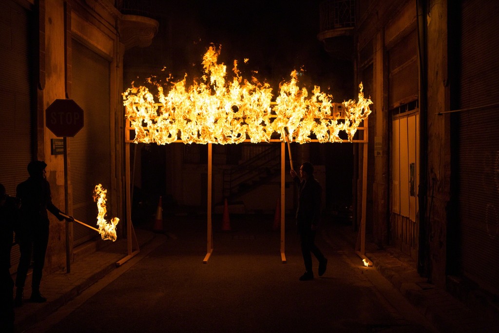 "All Kingdoms Smashed and Buried in the Sky" ablaze in a narrow street next to the buffer zone in Nicosia, Cyprus. Photography: Antonis Minas "All Kingdoms Smashed and Buried in the Sky" ablaze in a narrow street next to the buffer zone in Nicosia, Cyprus. Photography: Antonis Minas