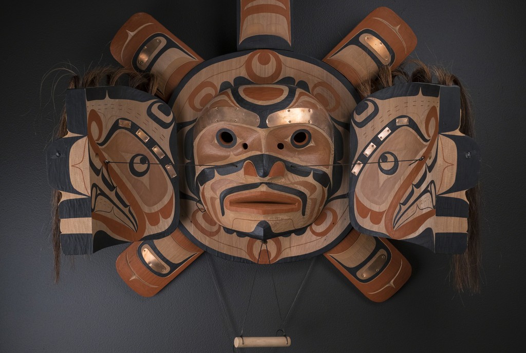 "Sun and Sisiutl Transformation Mask" by Calvin Hunt (Kwakwaka'wakw / Kwagiulth) – 2000
Red Cedar, Copper, Horsehair, Pigment, Twine, Fabric Backing
31"h x 29"w x 11.5"d "Sun and Sisiutl Transformation Mask" by Calvin Hunt (Kwakwaka'wakw / Kwagiulth) – 2000
Red Cedar, Copper, Horsehair, Pigment, Twine, Fabric Backing
31"h x 29"w x 11.5"d