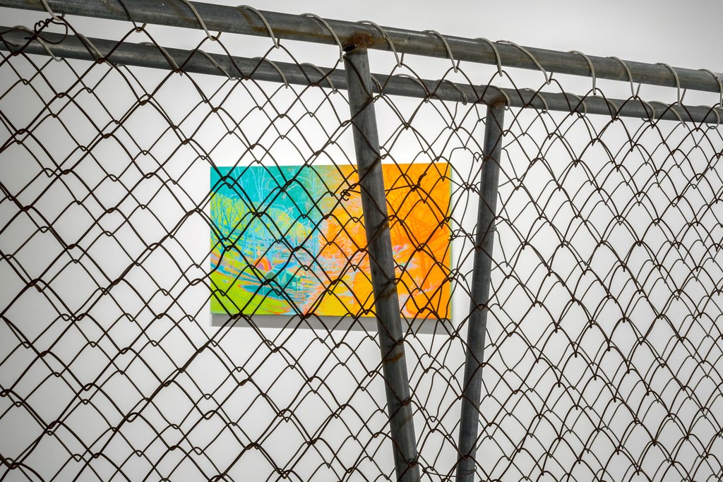 "Camp Jimmy" seen through a section of chain link fence at PROTO Gallery. "Camp Jimmy" seen through a section of chain link fence at PROTO Gallery.