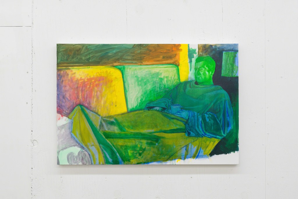 A painting of a main in a Snuggie by Phil Hardy on the rough factory wall of PROTO Gallery's second floor. A painting of a main in a Snuggie by Phil Hardy on the rough factory wall of PROTO Gallery's second floor.