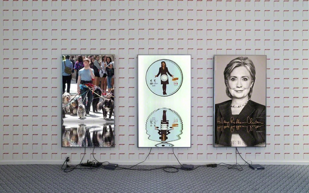 Cory Arcangel, “Lakes” (from left to right: “Dawgs / Lakes”, “Seinfeld DVD / Lakes”, “Hillary / Lakes”), 1920×1080 H.264/MPEG-4 Part 10 looped digital file (from 11 lossless TIF masters), media player, 65” flat screen, armature, various cables, Western Front, 2016. Photo by Maegan Hill-Carroll. Cory Arcangel, “Lakes” (from left to right: “Dawgs / Lakes”, “Seinfeld DVD / Lakes”, “Hillary / Lakes”), 1920×1080 H.264/MPEG-4 Part 10 looped digital file (from 11 lossless TIF masters), media player, 65” flat screen, armature, various cables, Western Front, 2016. Photo by Maegan Hill-Carroll.