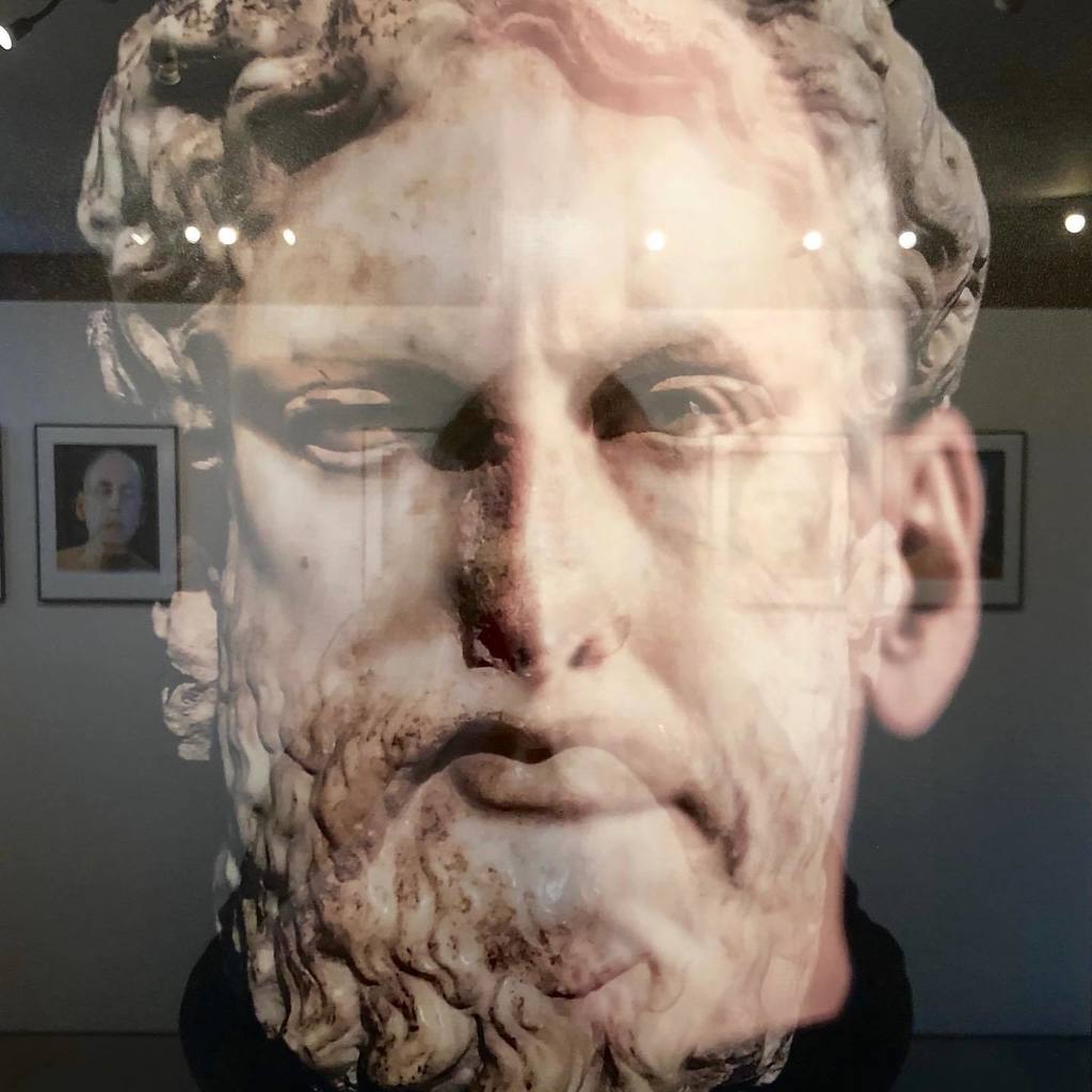 Deity (Zeus). David Weinberg superimposes self-portraits onto images ranging from mythological figures to animals to X-rays and everything in between. His reflection is one of identification with these icons, as he attempts to define his own persona. Deity (Zeus). David Weinberg superimposes self-portraits onto images ranging from mythological figures to animals to X-rays and everything in between. His reflection is one of identification with these icons, as he attempts to define his own persona.